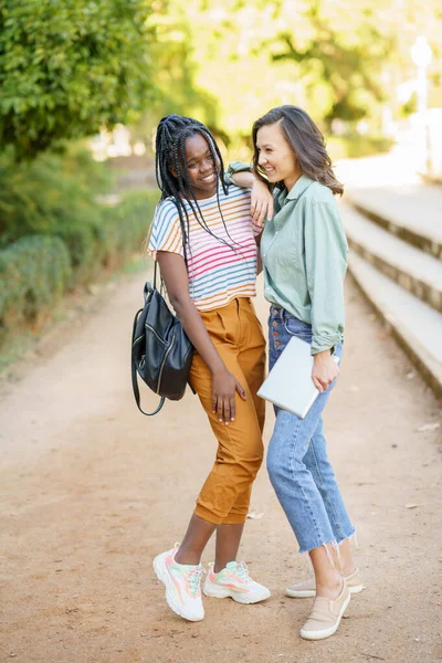 Dvě multietnické dívky pózující spolu s barevnými ležérní oblečení — Stock fotografie
