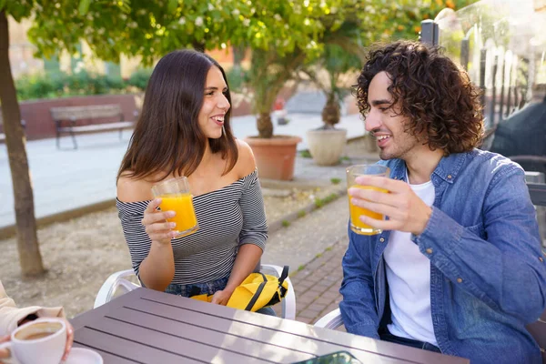 Un par de amigos brindando mientras toman una copa con su grupo multiétnico de amigos — Foto de Stock