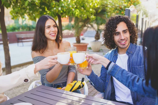 Multi-etnis kelompok teman bersulang dengan minuman mereka sambil minum bersama-sama. — Stok Foto