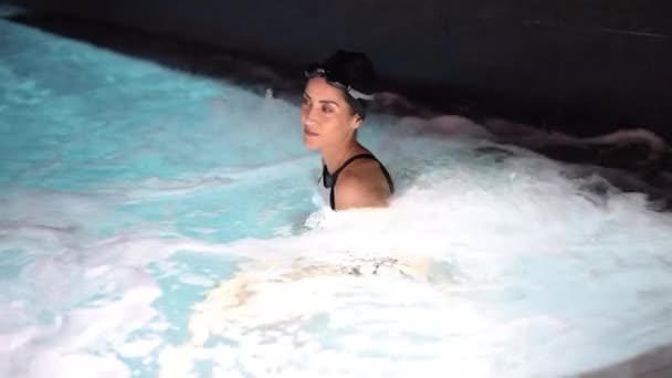 Middle-aged woman enjoying bubble bath in spa having hydro massage. — Stock Video