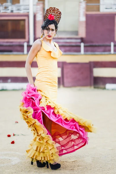 Woman, model of fashion, wearing a dress in a bullring — Stock Photo, Image