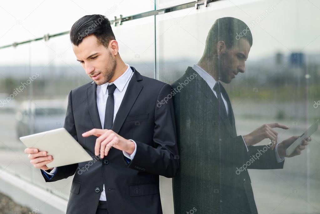 Businessman with tablet computer in office building