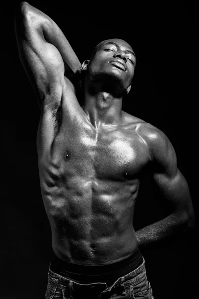 Athletic black man on black background — Stock Photo, Image