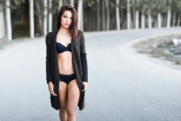 Woman in lingerie walking in a rural road — Stock Photo, Image