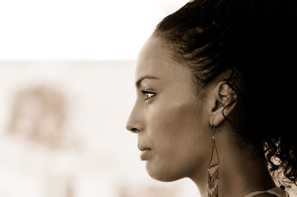 Black woman with earrings. Afro hairstyle