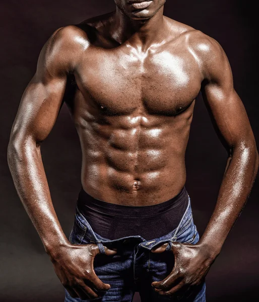 Athletic black man on black background — Stock Photo, Image