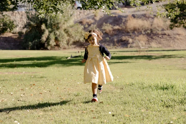 Маленькая девочка бегает и играет в парке — стоковое фото