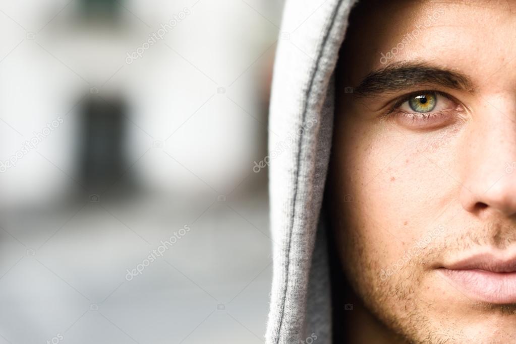 Handsome young man with blue eyes in urban background