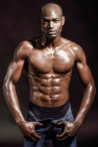 Athletic black man on black background — Stock Photo, Image