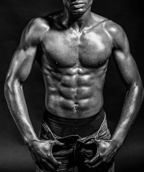 Athletic black man on black background — Stock Photo, Image