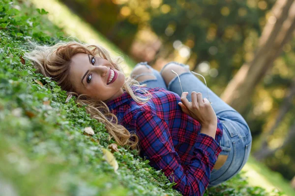 Beautiful woman with long blond curly hair — Stock Photo, Image