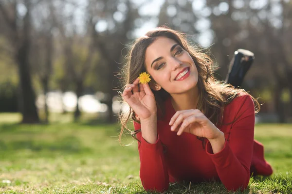 Woman rest in the park with dandelions — Stock Photo, Image