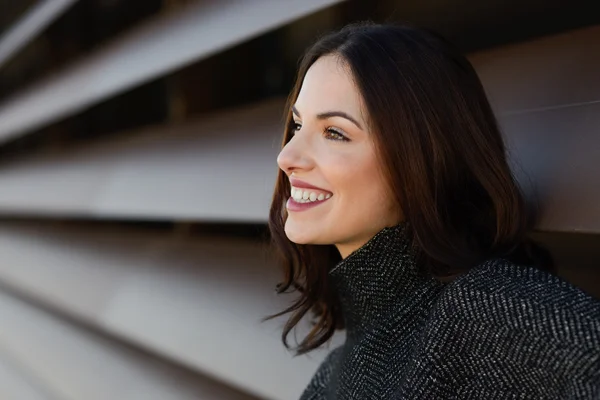 Young woman smiling in urban background