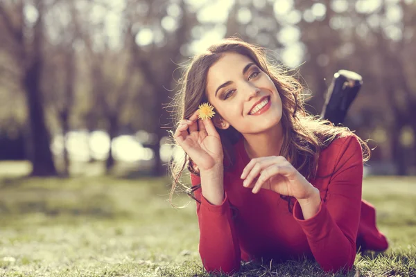 Woman rest in the park with dandelions — Stock Photo, Image