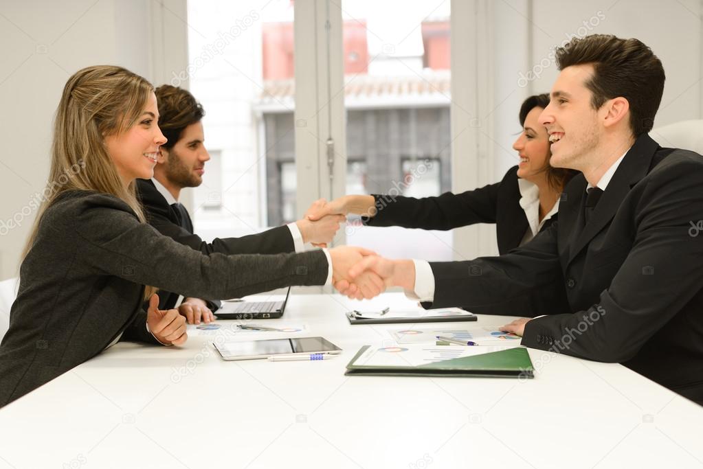 Business people shaking hands, finishing up a meeting 