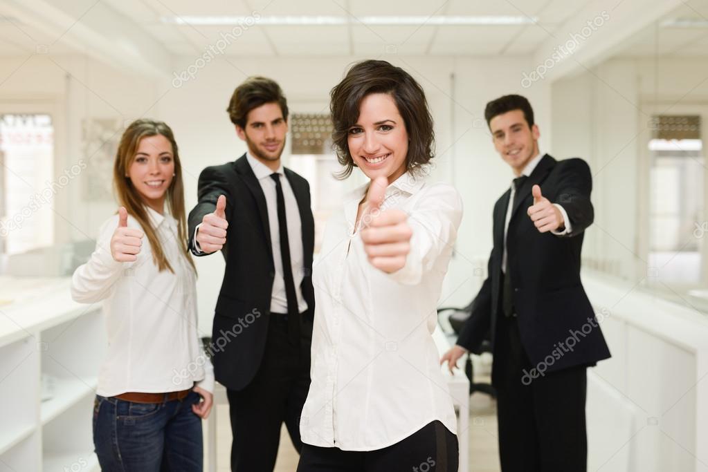 Cheerful business group giving thumbs up 