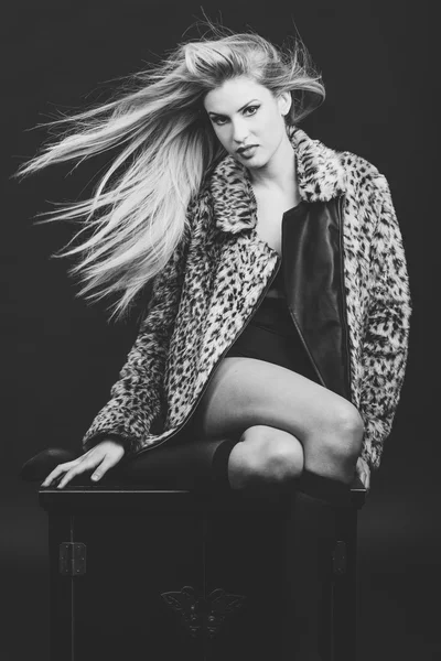 Fashion blond woman with flying hair wearing fur jacket — Stock Photo, Image