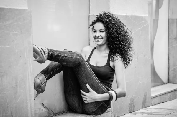 Mulher negra jovem, penteado afro, em fundo urbano — Fotografia de Stock