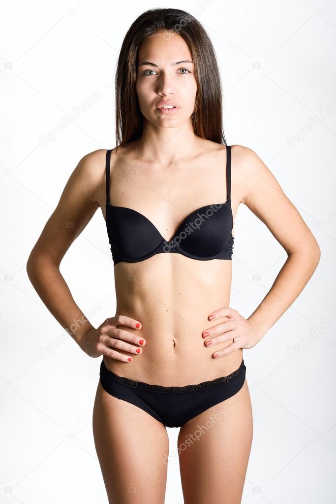 Beautiful woman wearing only black panties on white background