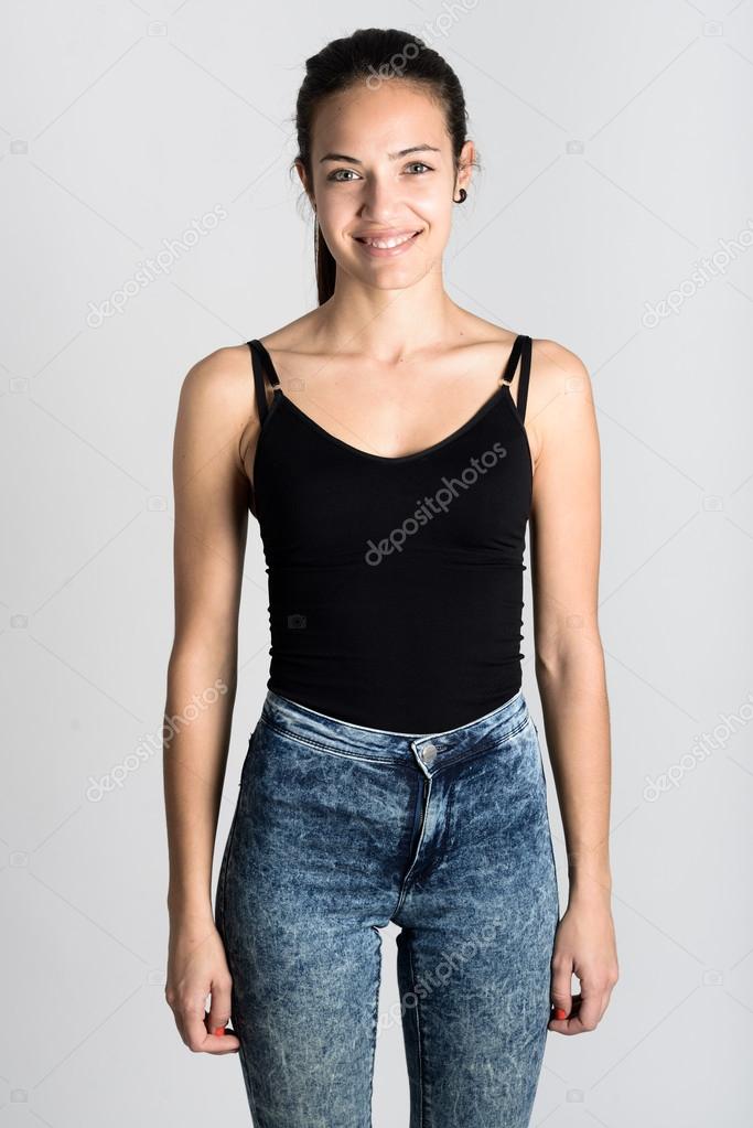 Young woman wearing black tank top and blue jeans Stock Photo by