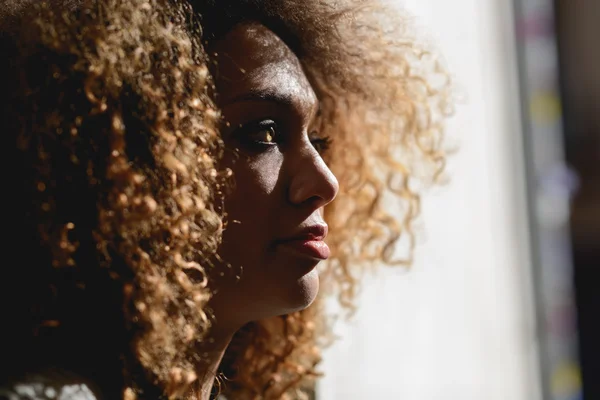 Young African American girl with afro hairstyle and green eyes Royalty Free Stock Photos