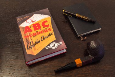 London, England, UK - January 2 2021: The ABC Murders Book by Agatha Christie in a Facsimile First Edition with Tobacco Pipe, Fountian Pen and Notebook, a Hercule Poirot Story clipart