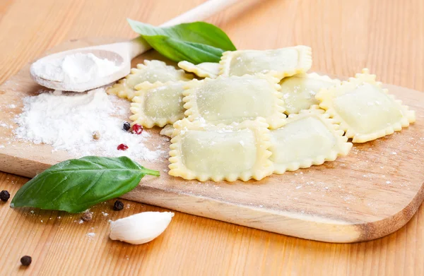 Raw ravioli and basil — Stock Photo, Image