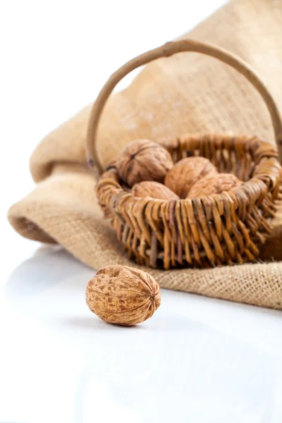 Close up of walnu on white background (wicker basket full walnu — стоковое фото