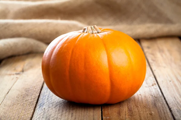 Autumn pumpkins on wooden board — Stock Photo, Image