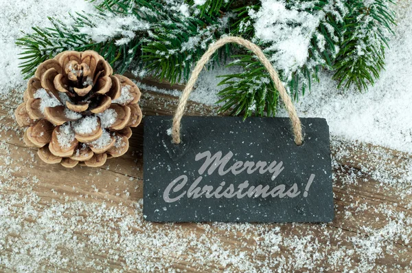 Black board of slate on old rustic wooden background, with snow — Stock Photo, Image