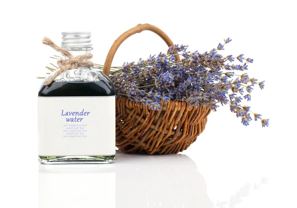 Dry lavender flower in a basket with lavender water, isolated on — Stock Photo, Image
