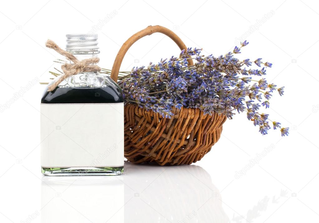 Dry lavender flower in a basket with lavender water, isolated on