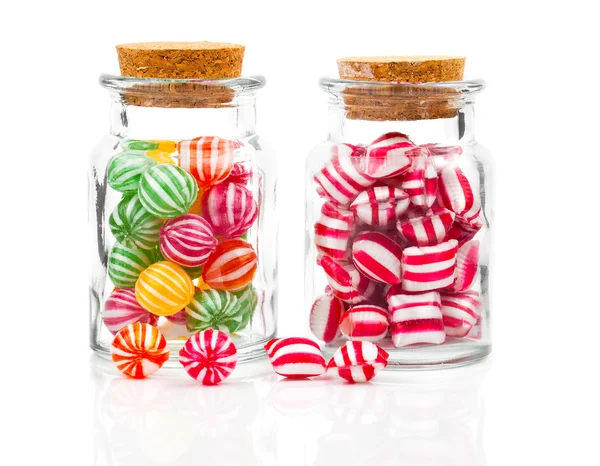 Two filled glass candy jars isolated over white background — Stock Photo, Image