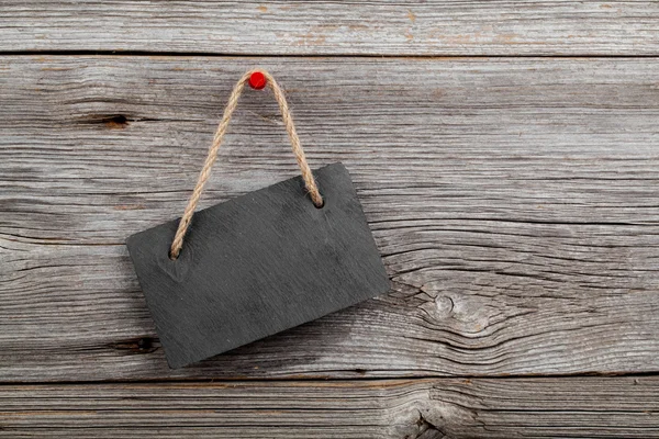 Black board of slate on old rustic wooden background. — Stock Photo, Image