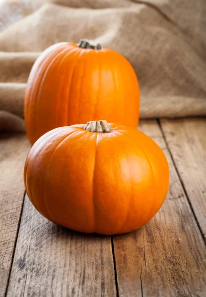 Autumn pumpkins on wooden board — Stock Photo, Image