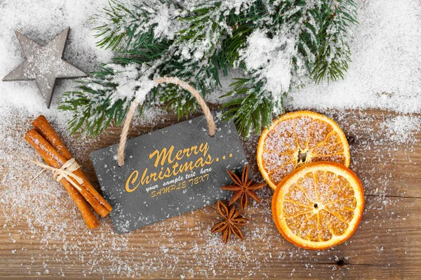 Christmas decoration with slate board, over wooden background — Stock Photo, Image