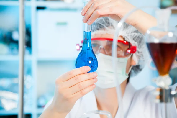 Pesquisador científico segurando em uma solução líquida em um laboratório — Fotografia de Stock