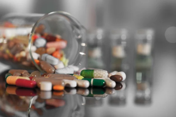 Colorful tablets with capsules and pills on background — Stock Photo, Image