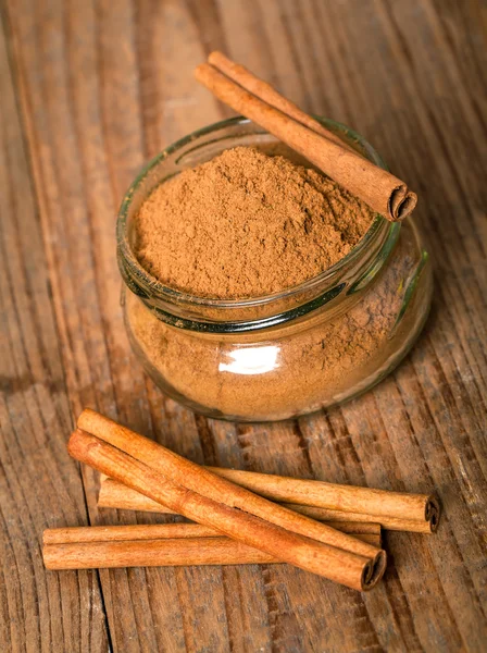 Cinnamon, or chinese cinnamon in the transparent glass jar with — Stock Photo, Image