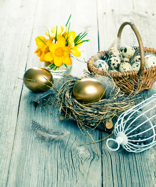 Golden egg of chickens in nest, on wooden background Royalty Free Stock Images