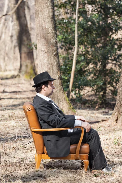 Man sitting alone in a armchair — Stock Photo, Image