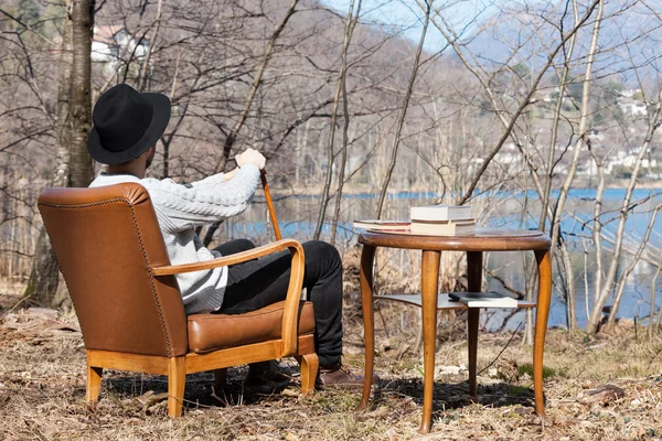 Homme lisant un roman dans les bois — Photo