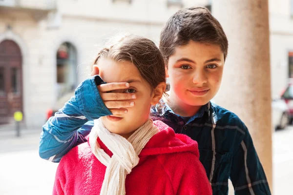 子は彼女の妹と一緒に彼の目をカバー肖像画 — ストック写真