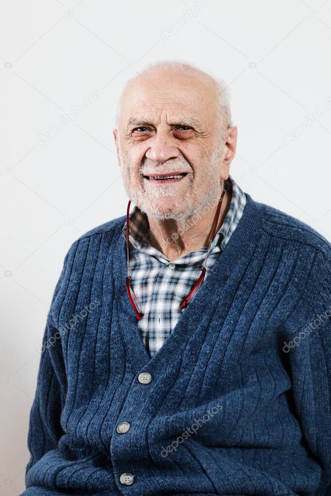 Senior gentleman in the studio on a white background, blue sweater