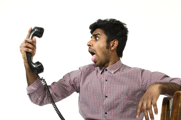 Young man struggling with a crazy telephone — Stock Photo, Image