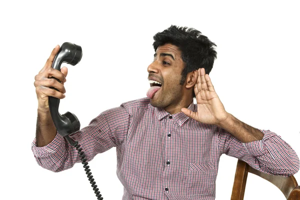 Young man struggling with a crazy telephone — Stock Photo, Image