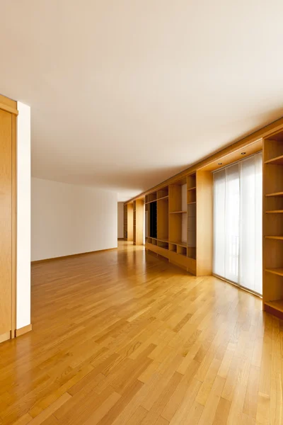 Wall bookcase in empty room — Stock Photo, Image