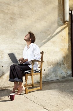 Defter üzerinde çalışma sandalyede oturan genç adam