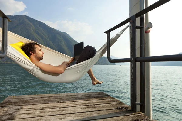 Young man on the dock of Lake — Stock Photo, Image