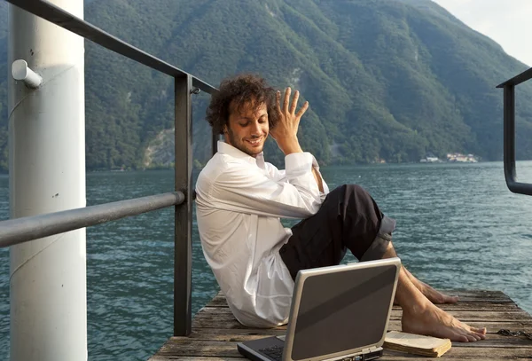 Young man on the dock of Lake — Stock Photo, Image